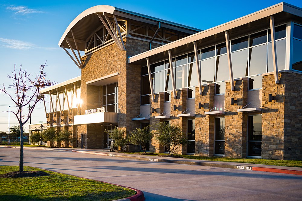 The stone-and-glass front of the Pearland Recreation Center and Natatorium.