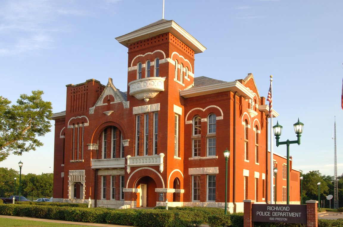 A red brick building with a central tower and a sign reading Richmond Police Department.
