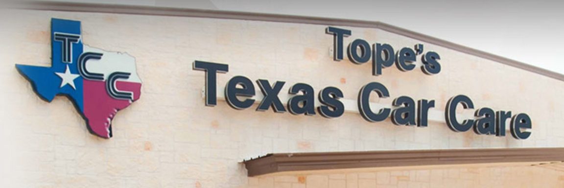 The Tope's Texas Car Care sign and Texas-flag logo on the shop's stone front
