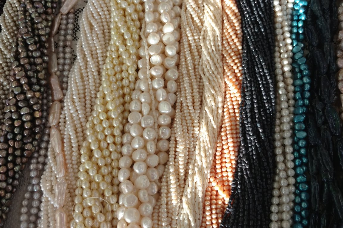 Strands of freshwater pearls and other beads in cream, peach, black and teal at Antiques, Beads & Crafty People