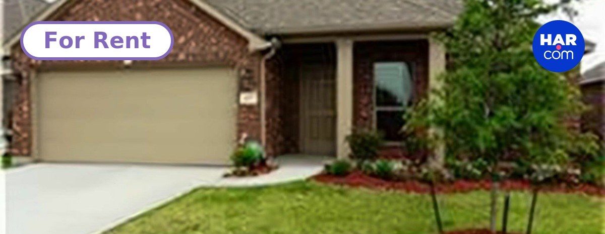 The front of 4713 E Meadow Dr in Deer Park, a one-story brick house with a two-car garage and a young tree in the front yard.