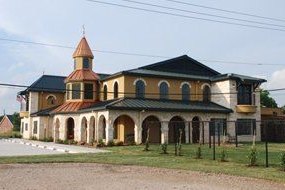 The limestone-and-stucco Rose-Rich Veterinary Clinic with its green metal roof and octagonal tower